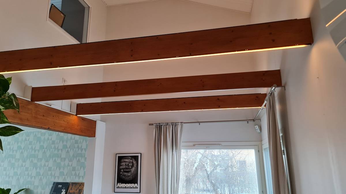 Indirect lighting in the living room can be achieved by installing fixtures in the beams.