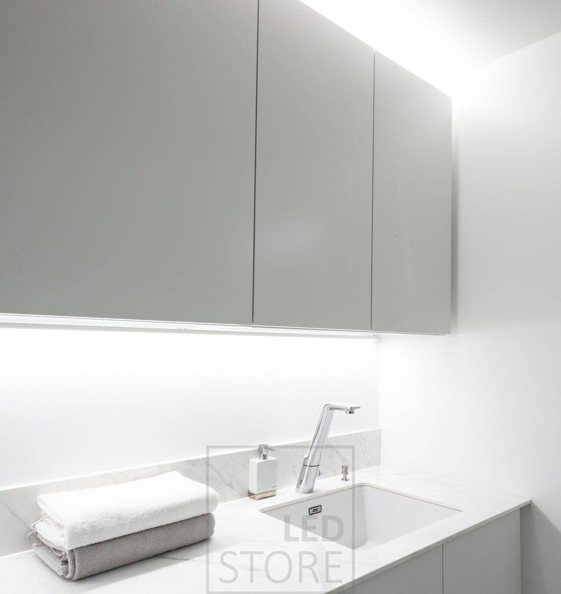 LED strip in the corner to bring light to the level, LED strip on top of the cabinets to create indirect light. Ledstore.fi