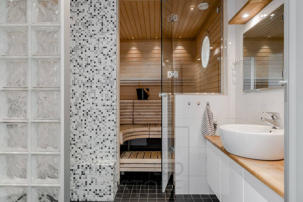 Creative and versatile sauna lighting — in this sauna, small spotlights have been used in the ceiling near the wall edge of the steam room.