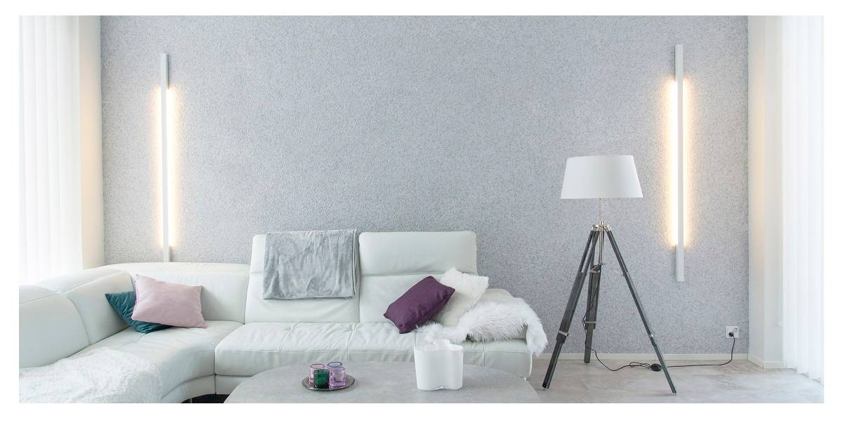 the lighting design of a living room is important, in the picture a harmonious living room with wall lights on the back wall