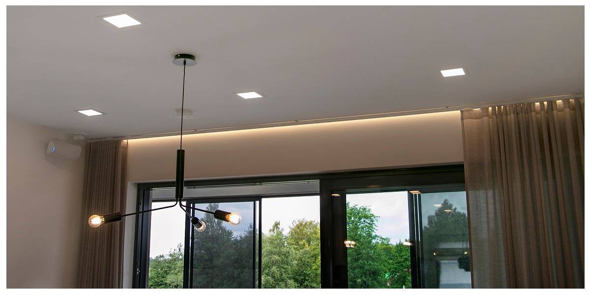 The living room lighting design has curtain lights between the window and the curtains to prevent direct views in at dark times from outside.