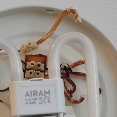 Close-up of deteriorated plastic parts in a fluorescent light fixture.