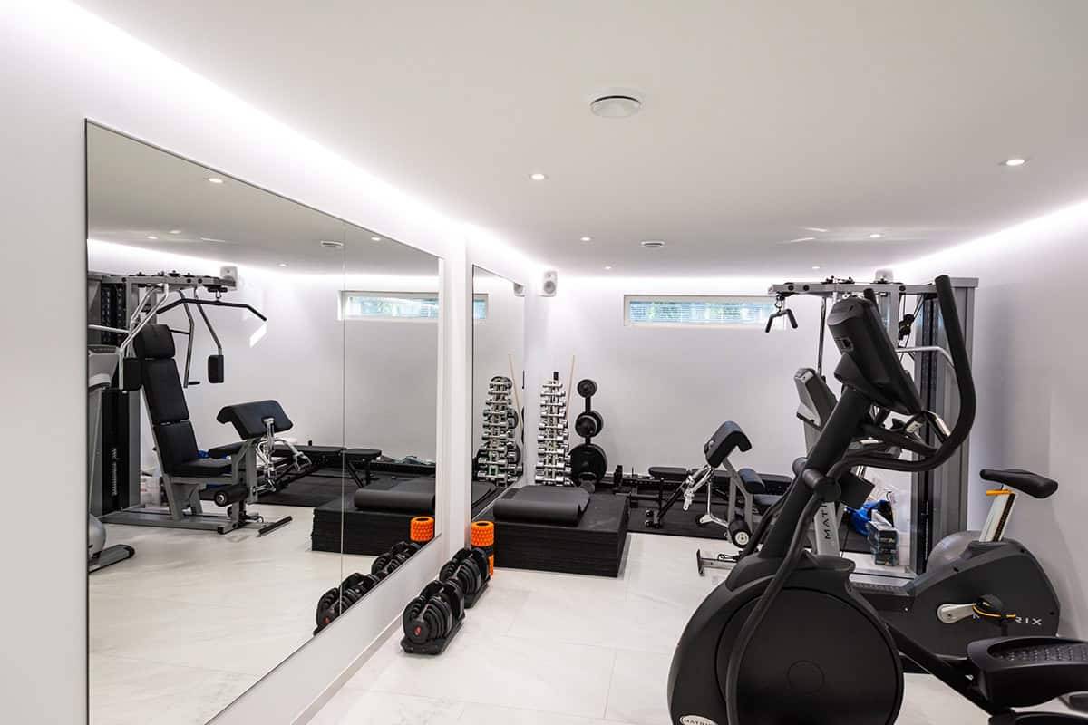 A small gym with LED strip lighting and spotlights.