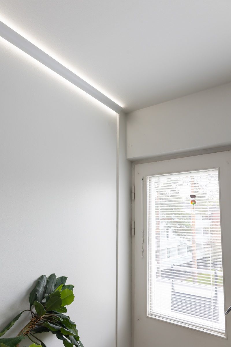 The gutter is not very visible from a distance, as there is a gap in the wall where it is located anyway.