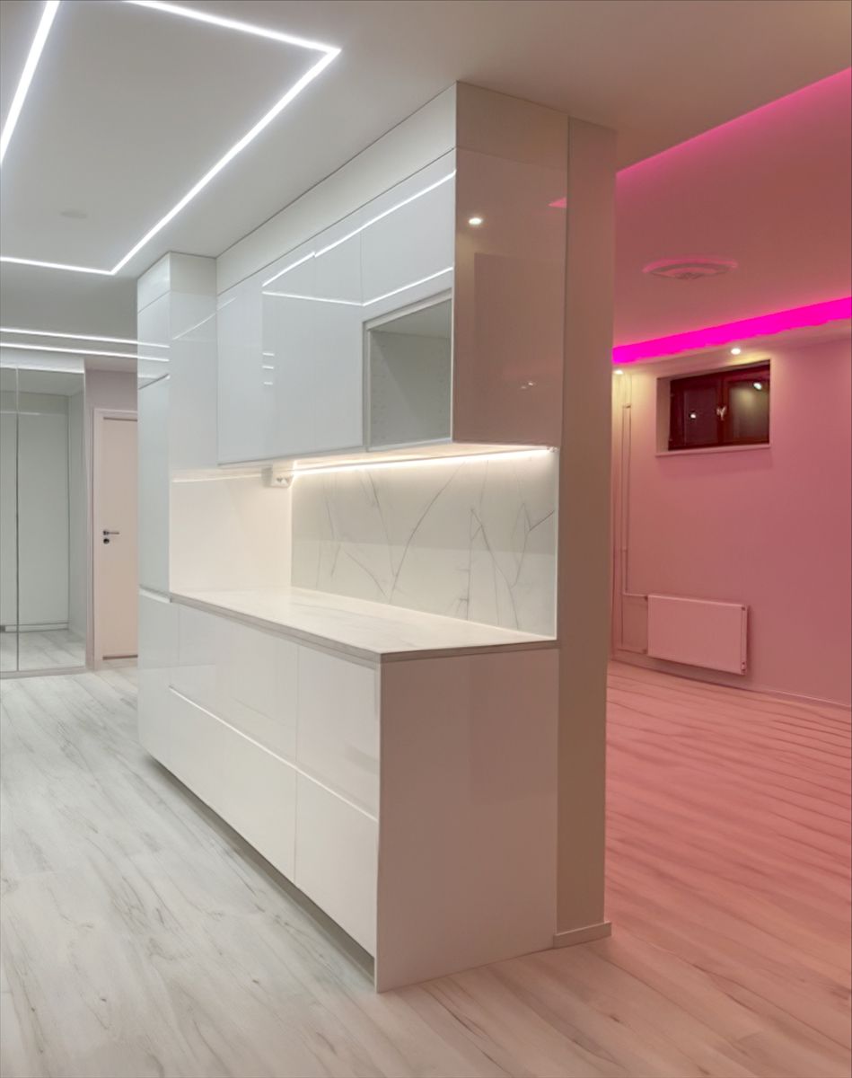 Square light line on the kitchen ceiling and pink led light in the living room.